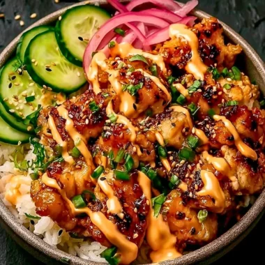 Crispy chicken topped with creamy spicy sauce served on jasmine rice