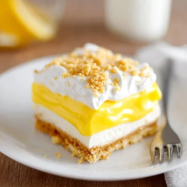 Slice of heavenly Oreo lemon dessert on a plate with lemon garnish