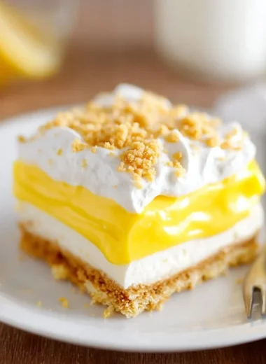 Slice of heavenly Oreo lemon dessert on a plate with lemon garnish