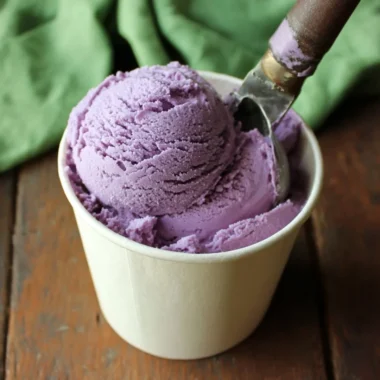 Bowl of homemade blueberry ice cream topped with fresh blueberries