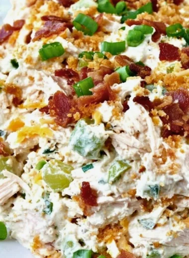Keto Jalapeño Popper Chicken Salad served in a bowl with jalapeños and herbs