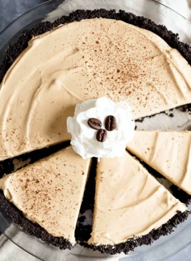 A delicious no-bake coffee pie topped with whipped cream and chocolate shavings