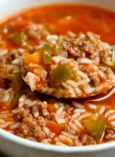 Bowl of delicious stuffed pepper soup garnished with herbs and bell peppers