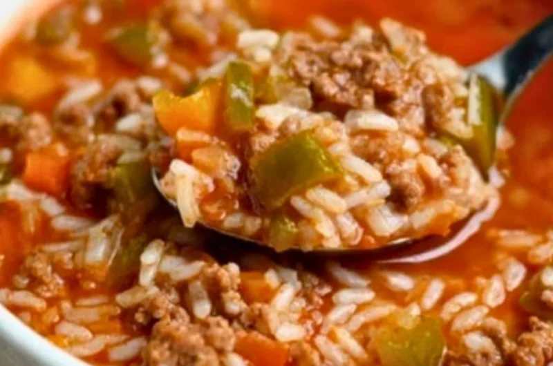 Bowl of delicious stuffed pepper soup garnished with herbs and bell peppers