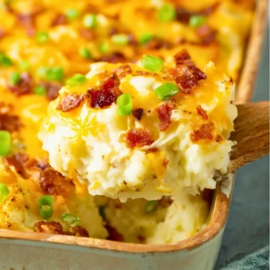 Delicious Twice Baked Potato Casserole topped with cheese and herbs