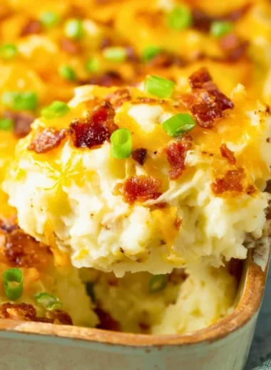 Delicious Twice Baked Potato Casserole topped with cheese and herbs