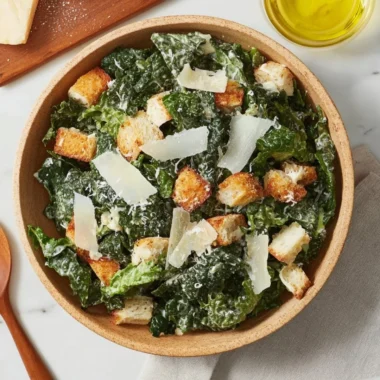5-Ingredient Kale Caesar Salad in a bowl with creamy dressing and croutons