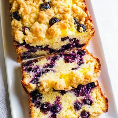 Freshly baked blueberry lemon loaf with a golden crust and vibrant blueberries