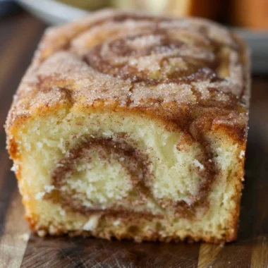Freshly baked cinnamon swirl donut bread with a golden crust and cinnamon filling