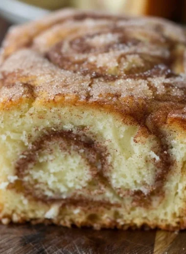 Freshly baked cinnamon swirl donut bread with a golden crust and cinnamon filling