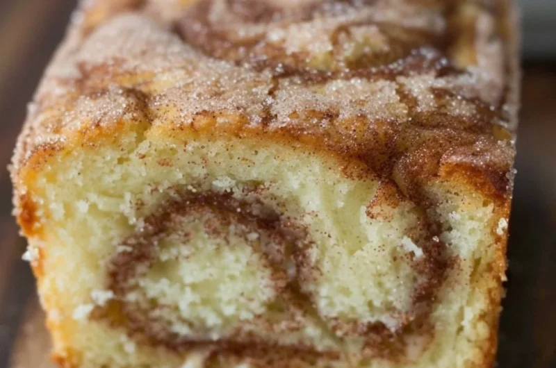 Freshly baked cinnamon swirl donut bread with a golden crust and cinnamon filling