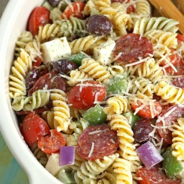 Bowl of classic pasta salad with fresh vegetables and dressing