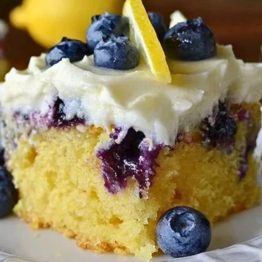 Cozy lemon blueberry poke cake with blueberries and lemon drizzle