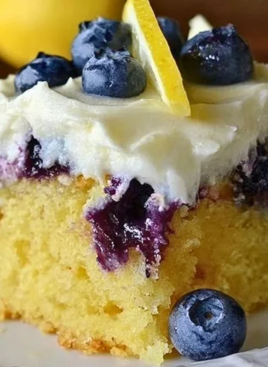 Cozy lemon blueberry poke cake with blueberries and lemon drizzle