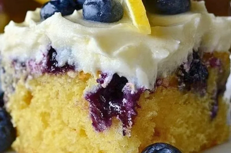 Cozy lemon blueberry poke cake with blueberries and lemon drizzle