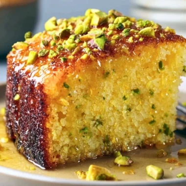 Cozy lemon pistachio cake decorated with fresh lemons and pistachios
