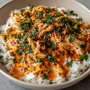 Crockpot Cajun Butter Chicken served in a bowl with herbs and spices