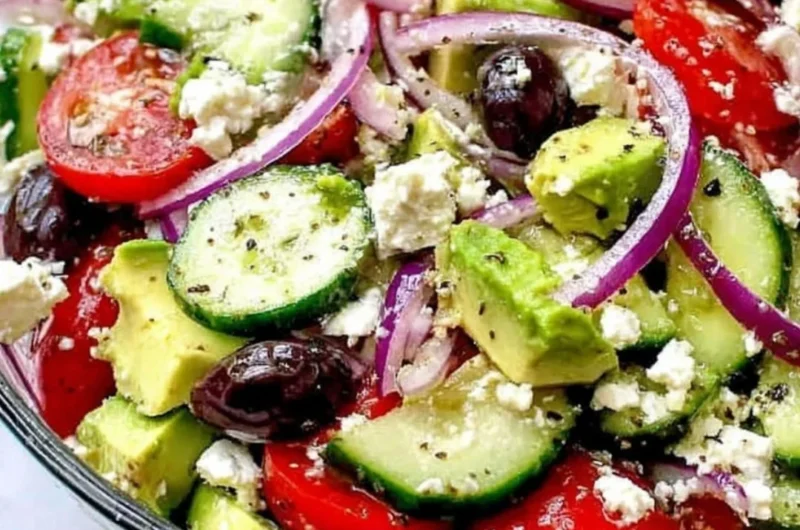 Refreshing Greek Salad with Avocado, tomatoes, cucumbers, and feta cheese.