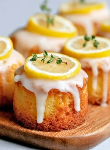 Delicious mini lemon drizzle cakes with a glossy lemon glaze on top.