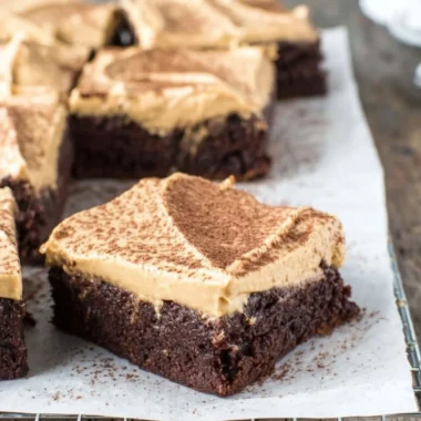 Delicious mocha brownies with café latte frosting on a decorative plate.