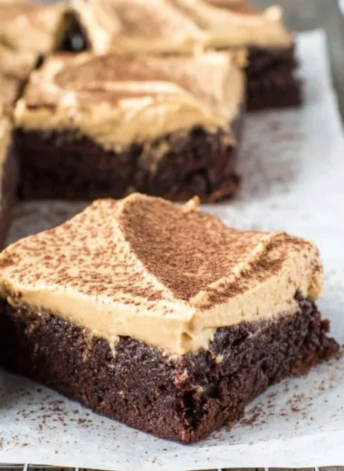 Delicious mocha brownies with café latte frosting on a decorative plate.