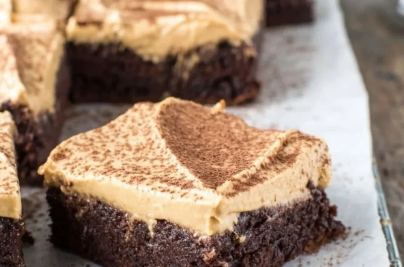 Delicious mocha brownies with café latte frosting on a decorative plate.