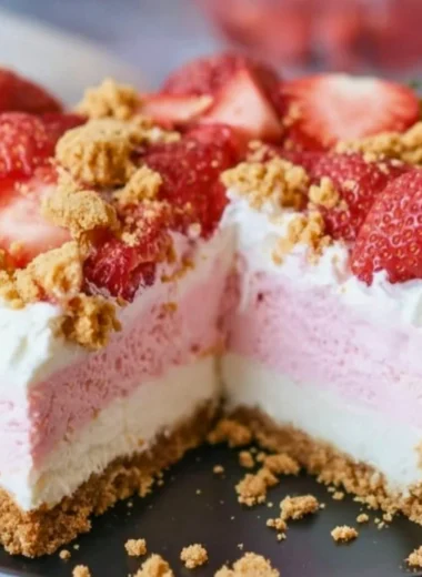 No-Bake Strawberry Crunch Cheesecake topped with fresh strawberries and crunchy crust.