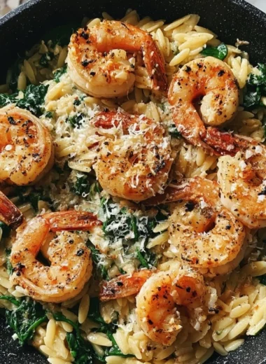 One Pan Parmesan Orzo with Shrimp dish garnished with herbs and spices.