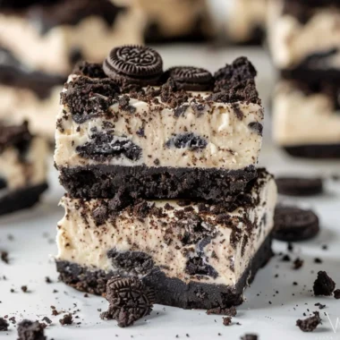 Oreo Cheesecake Bars with a crust made of crushed Oreos and creamy cheesecake filling