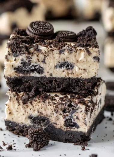 Oreo Cheesecake Bars with a crust made of crushed Oreos and creamy cheesecake filling