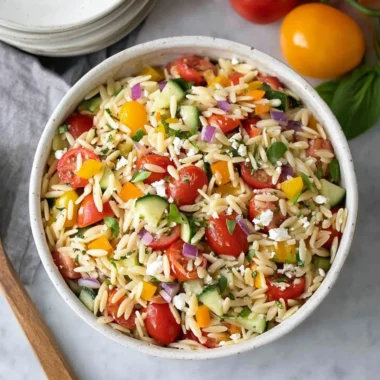 Colorful and fresh orzo salad with vegetables and dressing