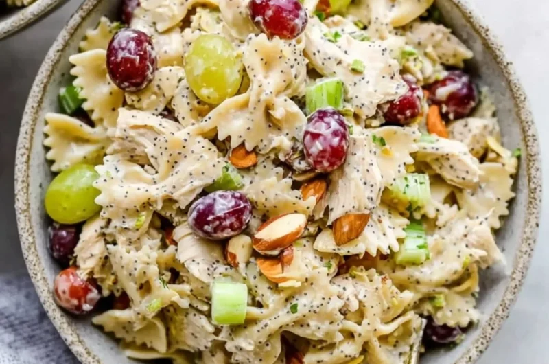 Poppyseed Chicken Pasta Salad served in a bowl garnished with herbs