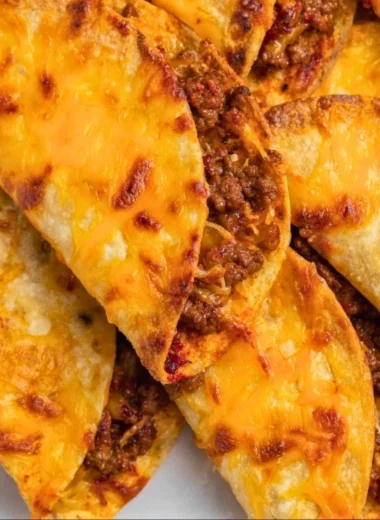 Delicious sheet pan tacos ready to serve with toppings on a baking tray.