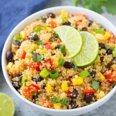 Bowl of vibrant Southwest Quinoa Salad with vegetables and dressing.