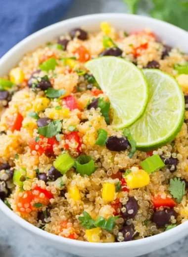 Bowl of vibrant Southwest Quinoa Salad with vegetables and dressing.
