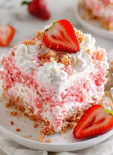 Delicious Strawberry Crunch Poke Cake topped with crunchy strawberry pieces