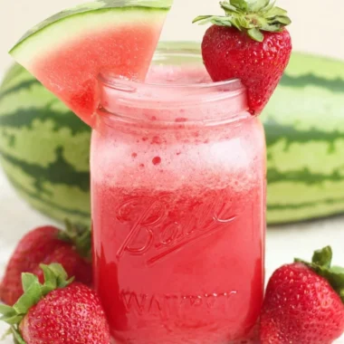 Glass of refreshing strawberry watermelon juice with cucumber slices