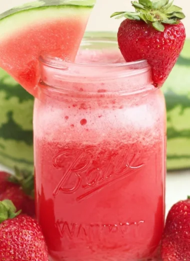 Glass of refreshing strawberry watermelon juice with cucumber slices