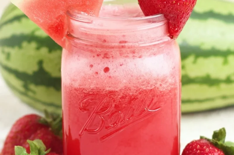 Glass of refreshing strawberry watermelon juice with cucumber slices