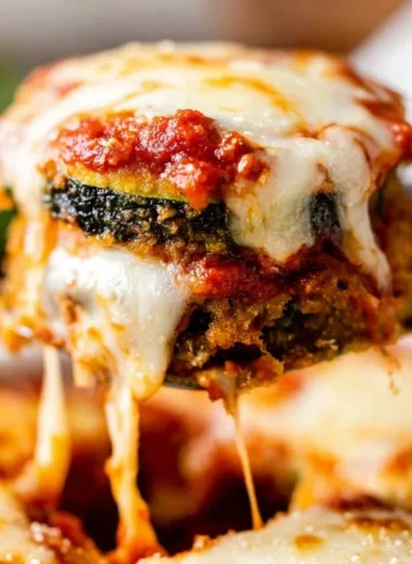 Delicious Zucchini Parmesan dish served on a plate with cheese and herbs