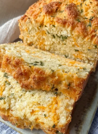 Freshly baked Cheddar Bay Biscuit Bread served on a wooden board