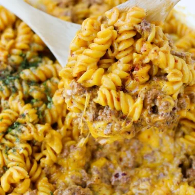 Bowl of creamy beef rotini pasta topped with fresh herbs