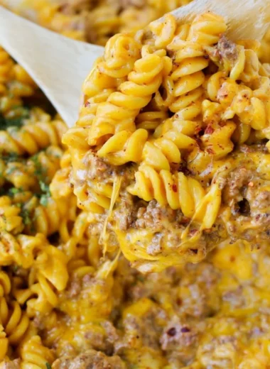 Bowl of creamy beef rotini pasta topped with fresh herbs