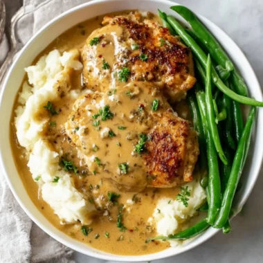 Delicious creamy garlic chicken served on a plate with fresh herbs
