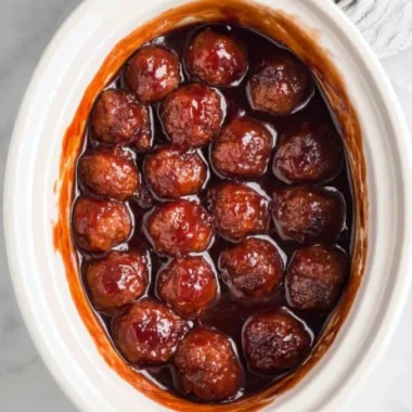 Crockpot BBQ grape jelly meatballs in a serving dish