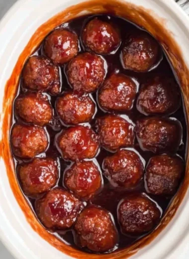 Crockpot BBQ grape jelly meatballs in a serving dish