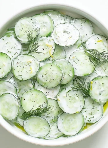 Fresh cucumber yogurt salad served in a bowl with herbs