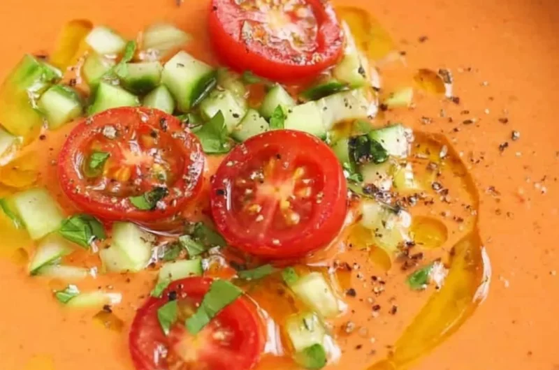 Bowl of easy gazpacho soup with fresh vegetables and herbs