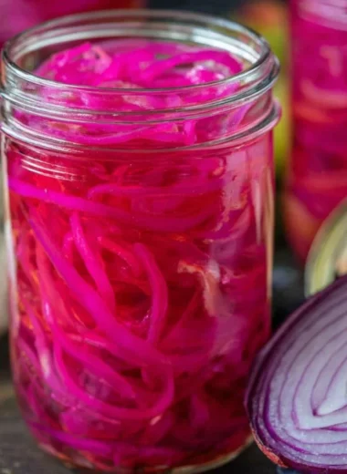 Jar of easy quick pickled red onions ready for serving.