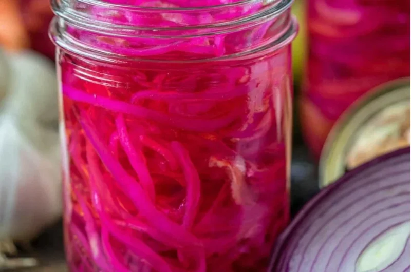 Jar of easy quick pickled red onions ready for serving.
